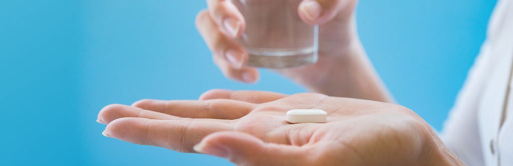 hand holding a large melatonin tablet