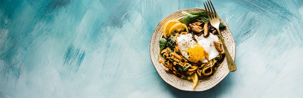 A paleo-friendly dish with eggs, mushrooms, and greens