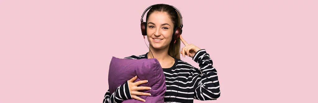 woman with pillow and sleeping ear muffs